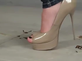 Diana quashing roaches in shooting sexy high heels.
