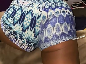 shaking ass over hem in booty shorts