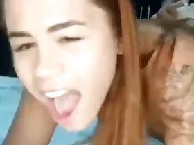Sexy redhead ordering pizza while taking weasel words