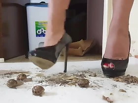 Sexy Latina crushing snails in high heels.