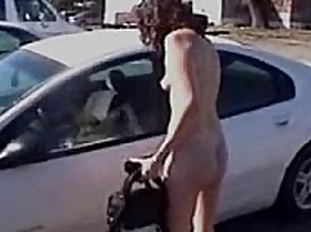 Nude woman driving a car