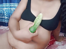 Well done unfocused is having intercourse in cucumber in her pussy.